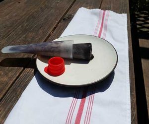 Chocolate Cold Brew Popsicle on a plate in the sunshine