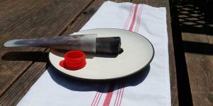 Chocolate Cold Brew Popsicle on a white plate in the sunshine