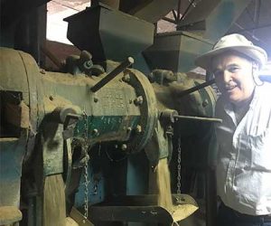 Edwardo of OVM Mill proudly shows the coffee milling machine on Ladro Roasting's Peru Coffee Buying trip 2017