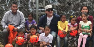 Jack Kelly in El Salvador watching children play with newly donated soccer balls
